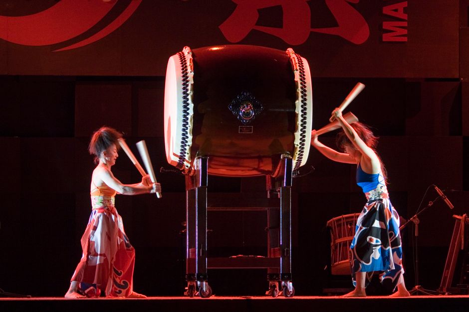 Intriguing taiko drummers in traditional attire deliver an energetic performance on stage.